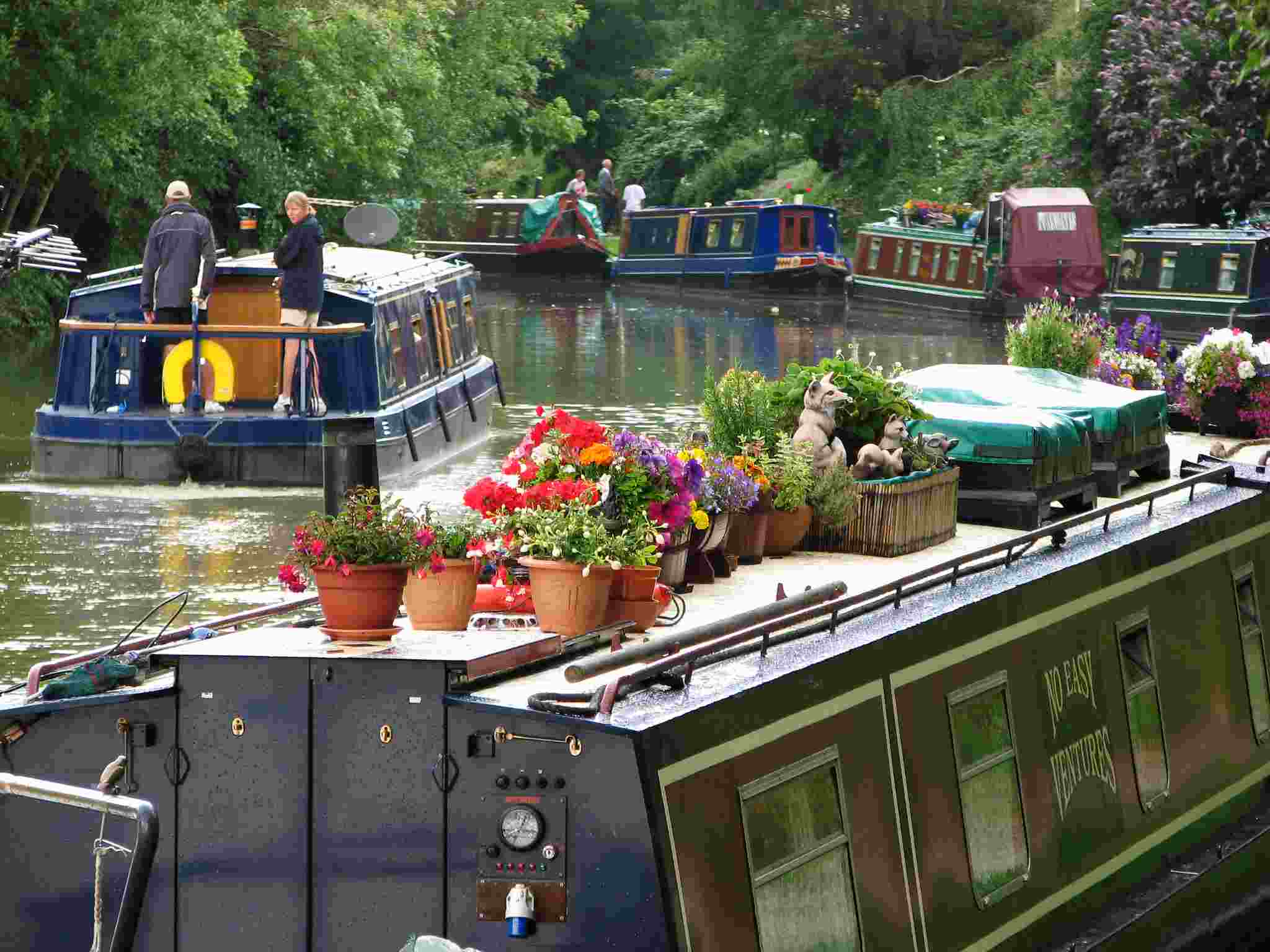 canal boats with floral arrangements on roof deck