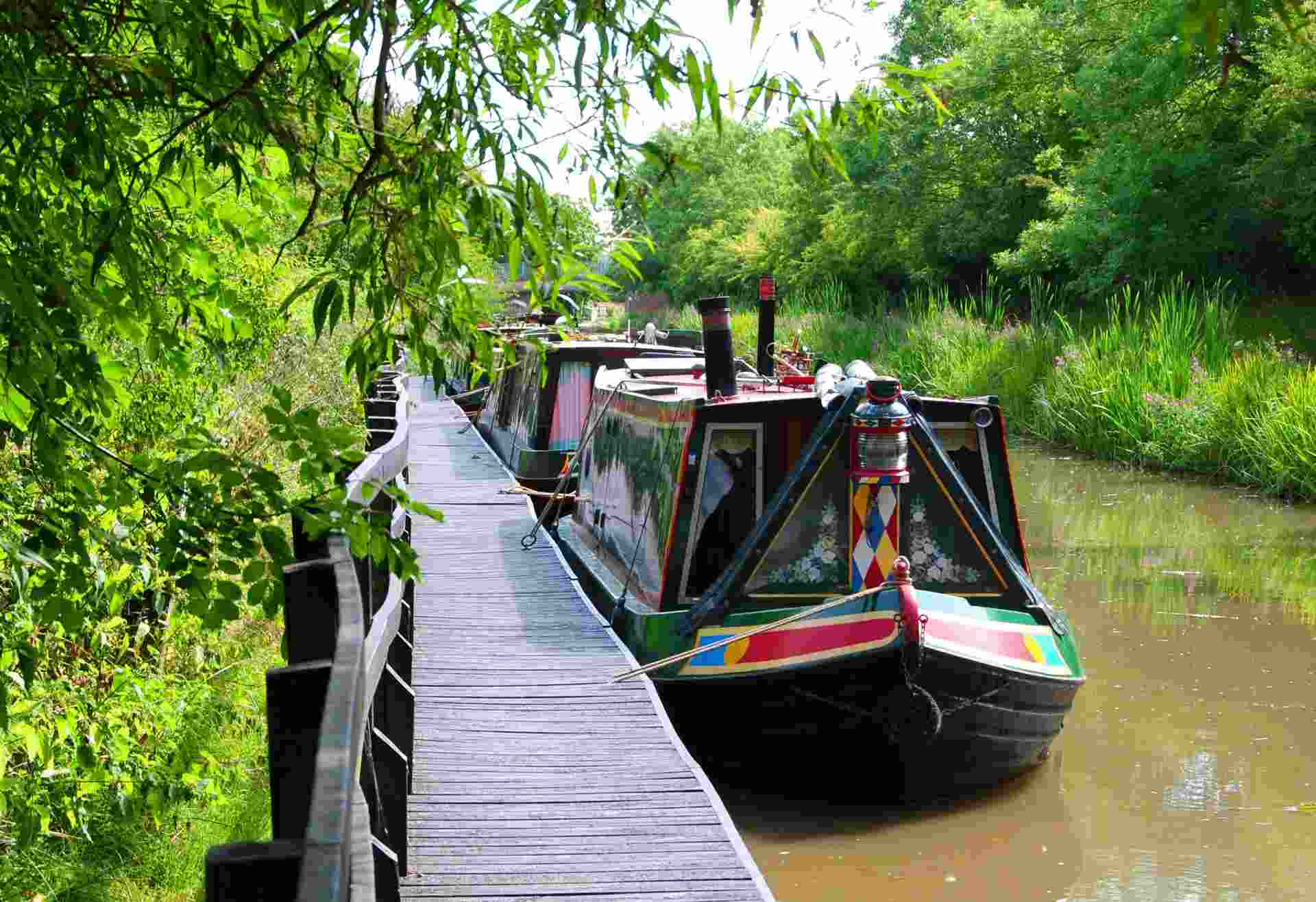 narrowboats docked by canal