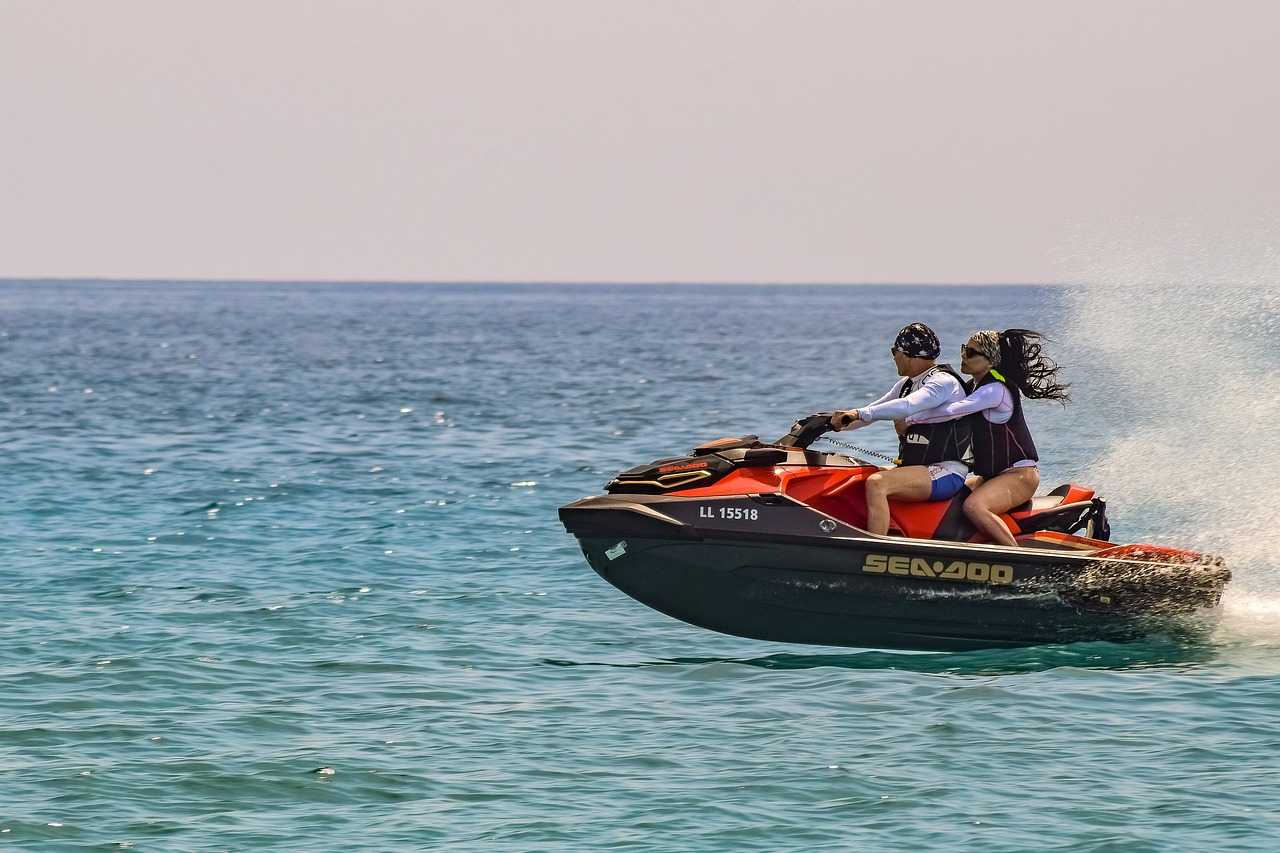 man and woman jet skiing