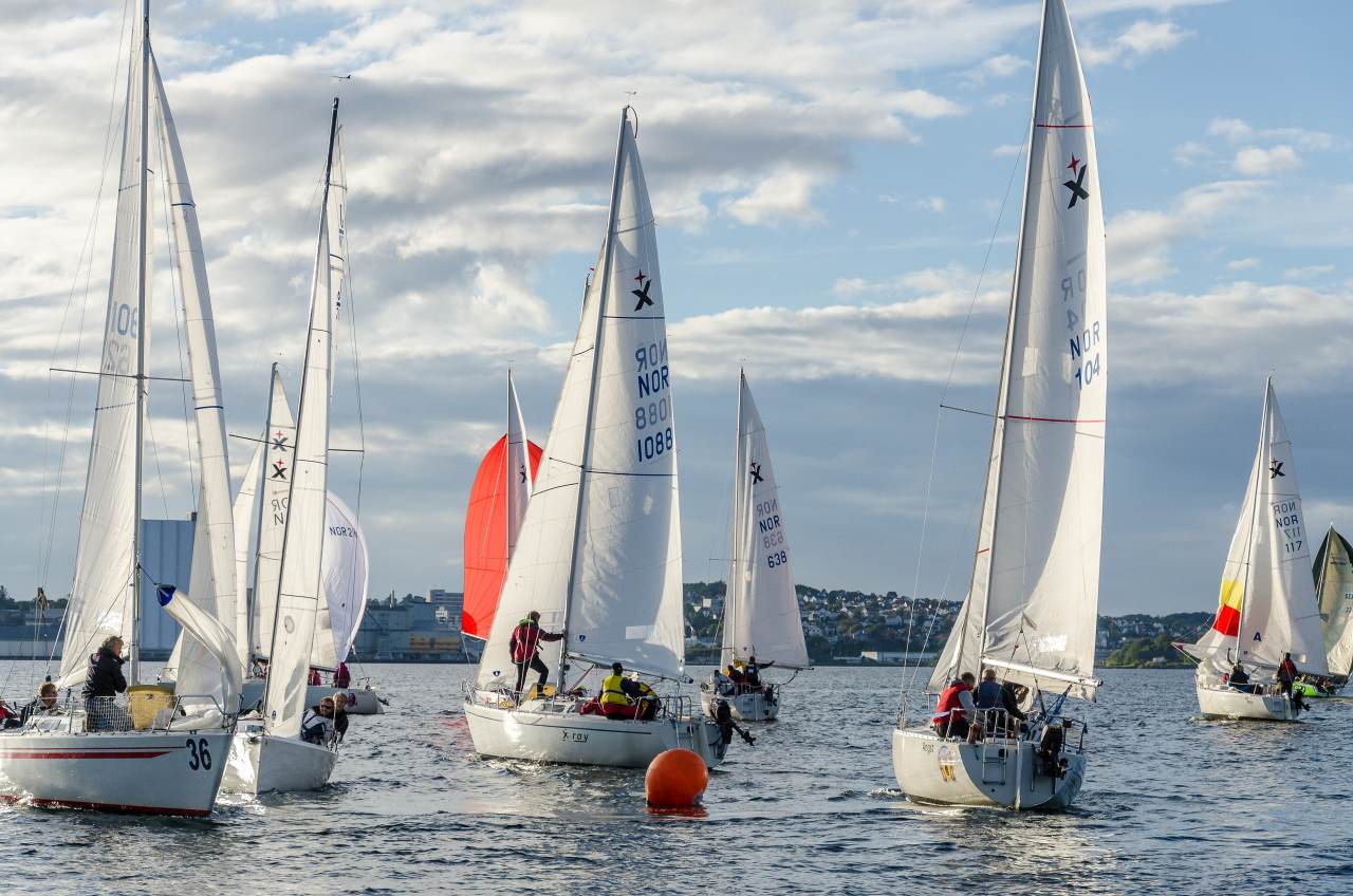 a group of sailing yachts racing