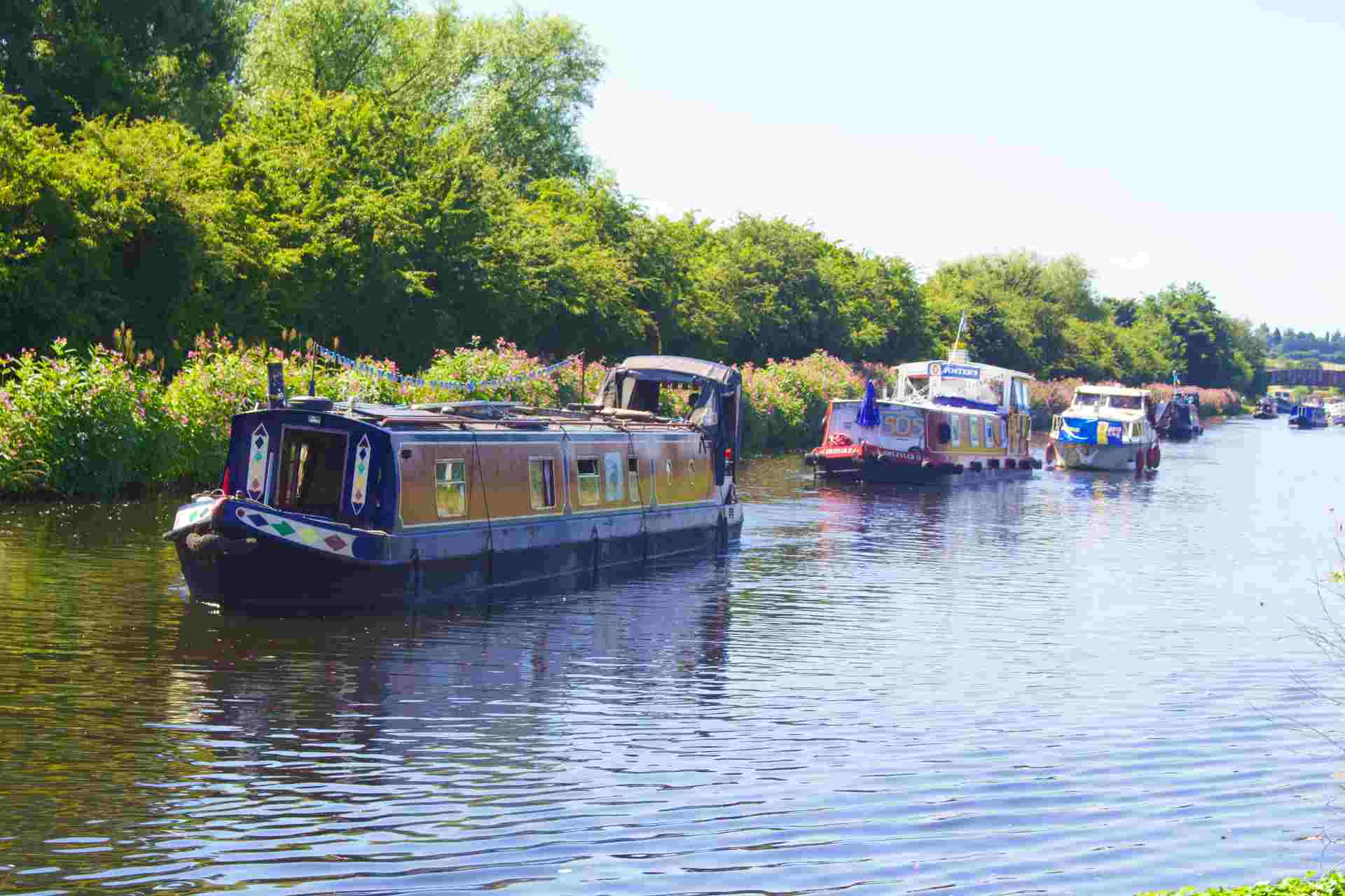 line of narrowboats canalside