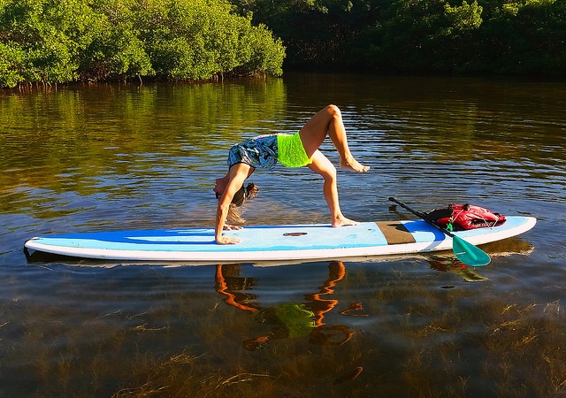 woman exercising on paddle board