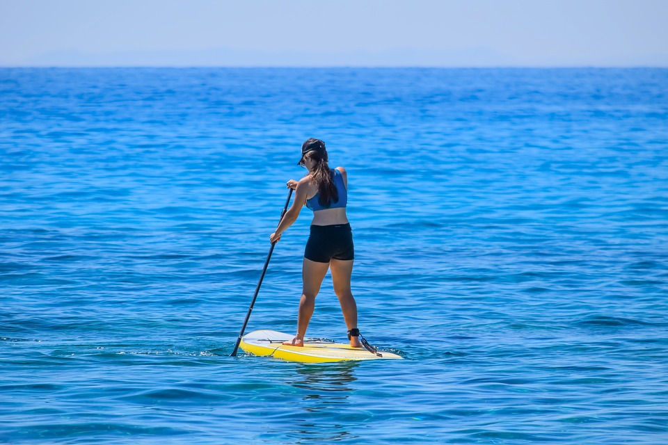 woman on paddle board at sea